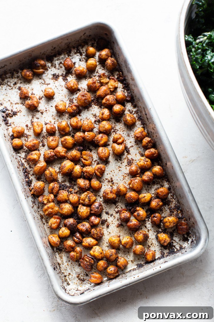 Spiced and roasted chickpeas on a baking sheet, golden and crispy