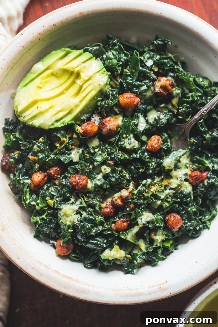 A close-up of the vibrant massaged kale chickpea salad, highlighting the textures and colors.