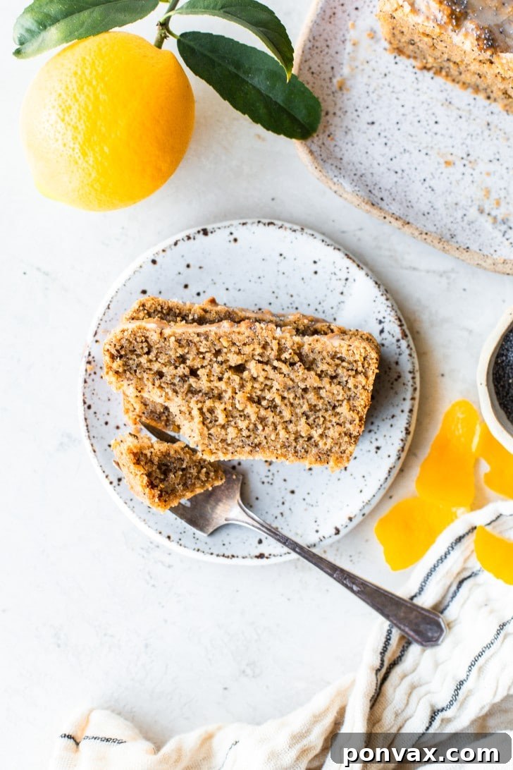 Zesty Gluten-Free Lemon Poppyseed Loaf 6 Several slices of Gluten-Free Lemon Poppyseed Loaf Cake on a wooden board.