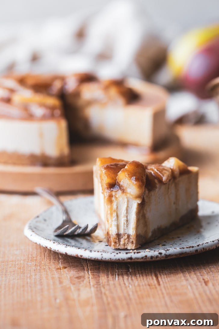 A visually stunning No-Bake Vegan Pear Cheesecake topped with glistening caramelized pears, ready for serving.