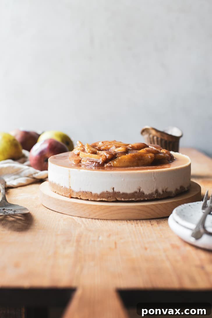 A close-up view of a single slice of No-Bake Vegan Pear Cheesecake, revealing its creamy layers and rich pear topping.