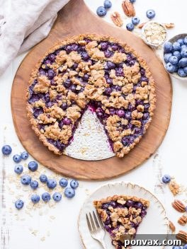 This Blueberry Crisp Tart with Oatmeal Crust comes together quickly and easily, and it's the perfect use for your fresh blueberries! This simple recipe is gluten-free & vegan.