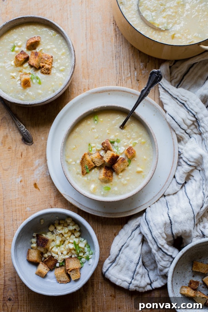 Golden Vegan Corn Chowder 2 A vibrant bowl of Vegan Corn Chowder, garnished with fresh herbs and corn kernels.