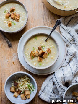 A bowl of creamy Vegan Corn Chowder with fresh corn and chives.