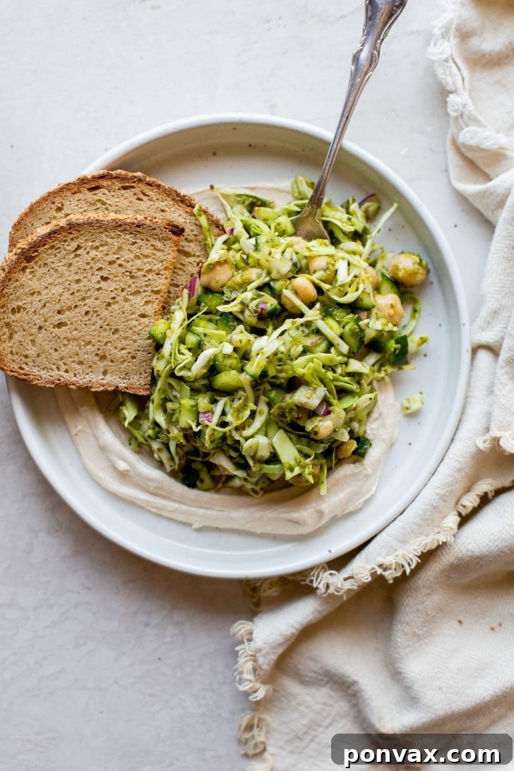Vibrant Five Ingredient Chimichurri Chickpea Salad 6 A bowl of 5-Ingredient Chickpea Chimichurri Salad with a fork resting inside, ready to be enjoyed.
