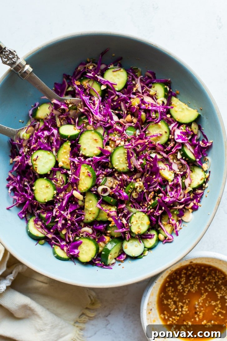 A bowl of Cabbage Cucumber Salad with Miso Sesame Dressing, ready to be served.