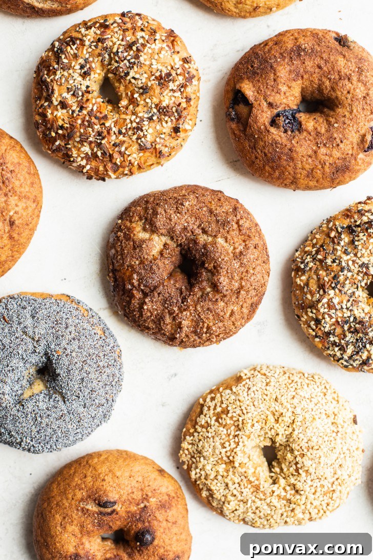 Freshly baked gluten-free bagels with various toppings like everything seasoning and sesame seeds.