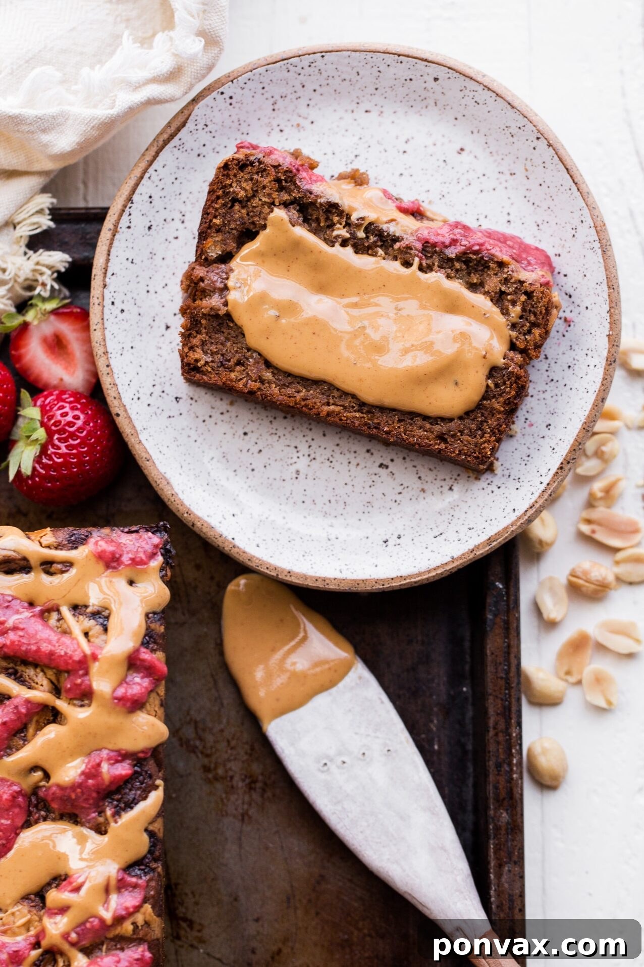 This Peanut Butter & Jelly Banana Bread will remind you of a PB&J sandwich, but in soft & sweet banana bread form. This recipe is gluten-free, vegan, and layered with homemade strawberry chia jam and creamy peanut butter.