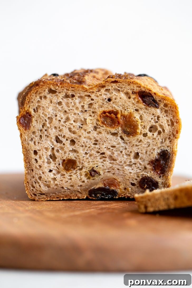 A side view of the Gluten-Free Cinnamon Raisin Bread, showcasing its golden crust and plump raisins.