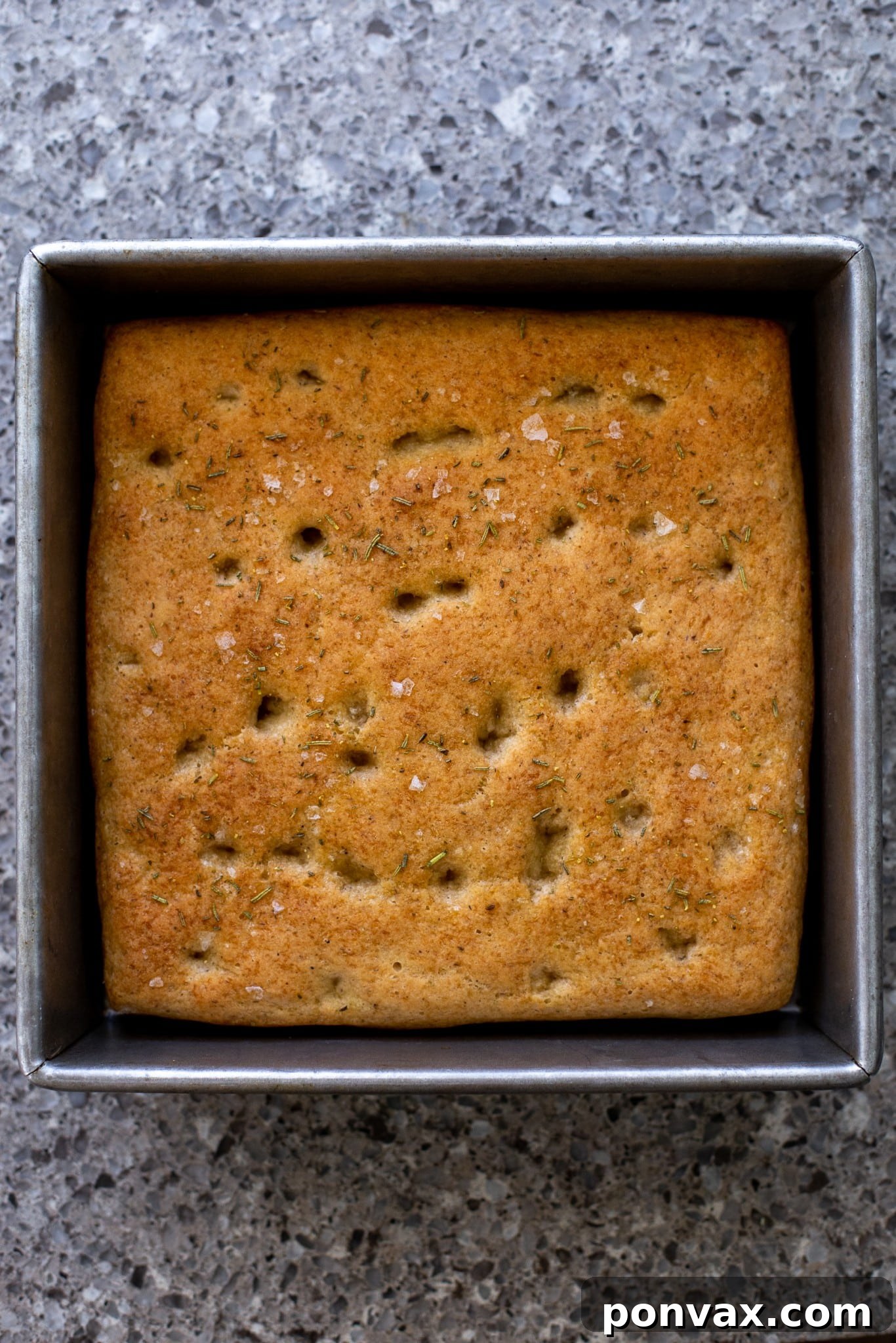 Effortless Gluten-Free Focaccia 13 The baked focaccia on a cutting board, ready to be sliced.