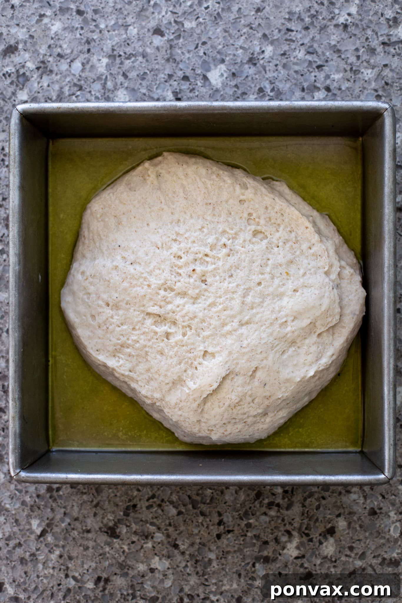 Effortless Gluten-Free Focaccia 10 Close-up of the dough being spread evenly in the pan.