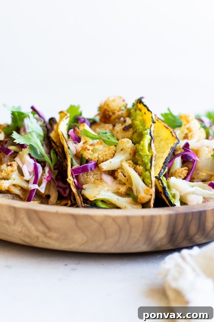 Zesty Roasted Cauliflower Tacos with Tangy Cabbage Slaw 6 Another mouth-watering shot of a completed Vegan Cauliflower Taco, garnished with fresh cilantro.