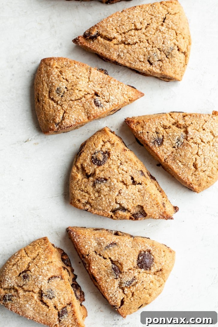 A selection of Gluten-Free Sourdough Discard Scones cooling on a wire rack, with a soft-focus background of a rustic kitchen, highlighting their homemade appeal.