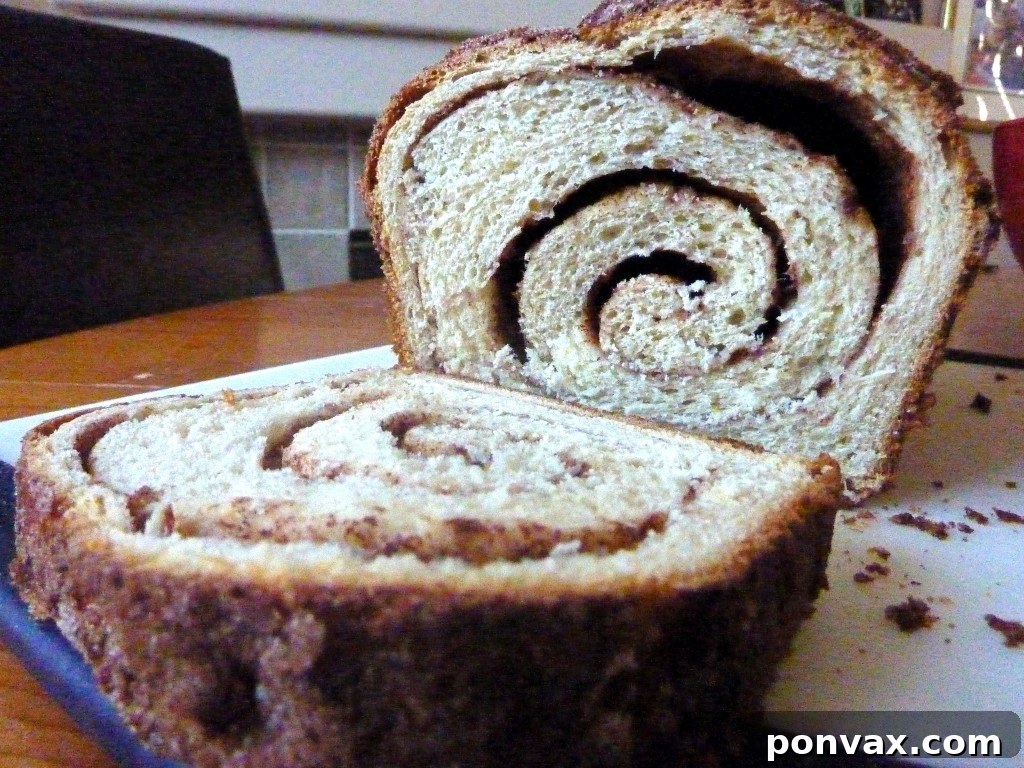 Best Cinnamon Swirl Bread Recipe Close-up of a slice of Cinnamon Swirl Bread, showing the distinct layers of cinnamon sugar.