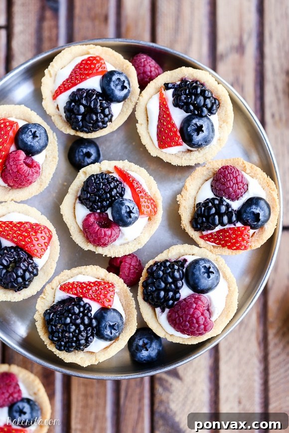 Bite-Sized Gluten-Free Vegan Berry Tarts 3 Close-up of freshly baked mini berry tarts with golden brown shortbread crusts, ready for filling.