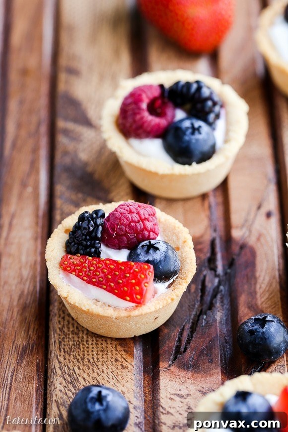 Bite-Sized Gluten-Free Vegan Berry Tarts 4 A tray of finished gluten-free and vegan mini berry tarts, garnished with fresh berries and ready to serve.