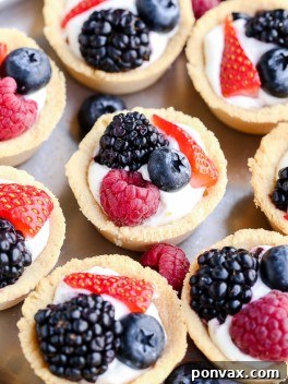 These Mini Berry Tarts have a shortbread crust with coconut cream filling and fresh berries! These sweet dessert bites are Paleo, gluten-free, and vegan.