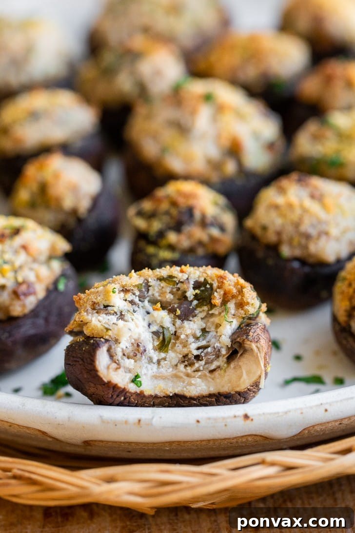 Savory Vegan Mushroom Bites 3 A cluster of vegan stuffed mushrooms on a baking sheet, ready to be baked.