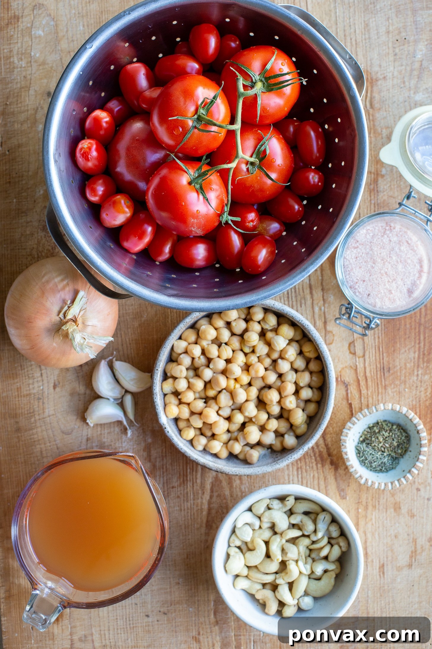 Sun Kissed Roasted Tomato and Chickpea Comfort 3 Close-up of creamy roasted tomato chickpea soup with tender chickpeas and a garnish of fresh basil.