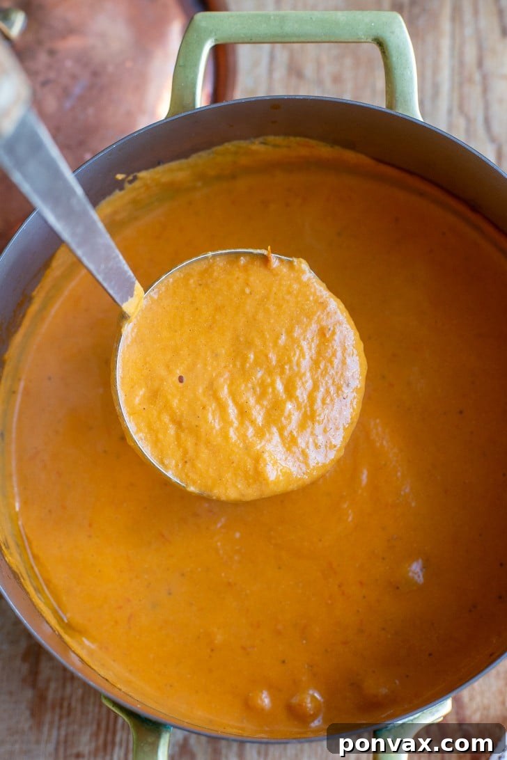 Sun Kissed Roasted Tomato and Chickpea Comfort 9 Delicious roasted tomato chickpea soup served in a rustic bowl with crusty bread for dipping.