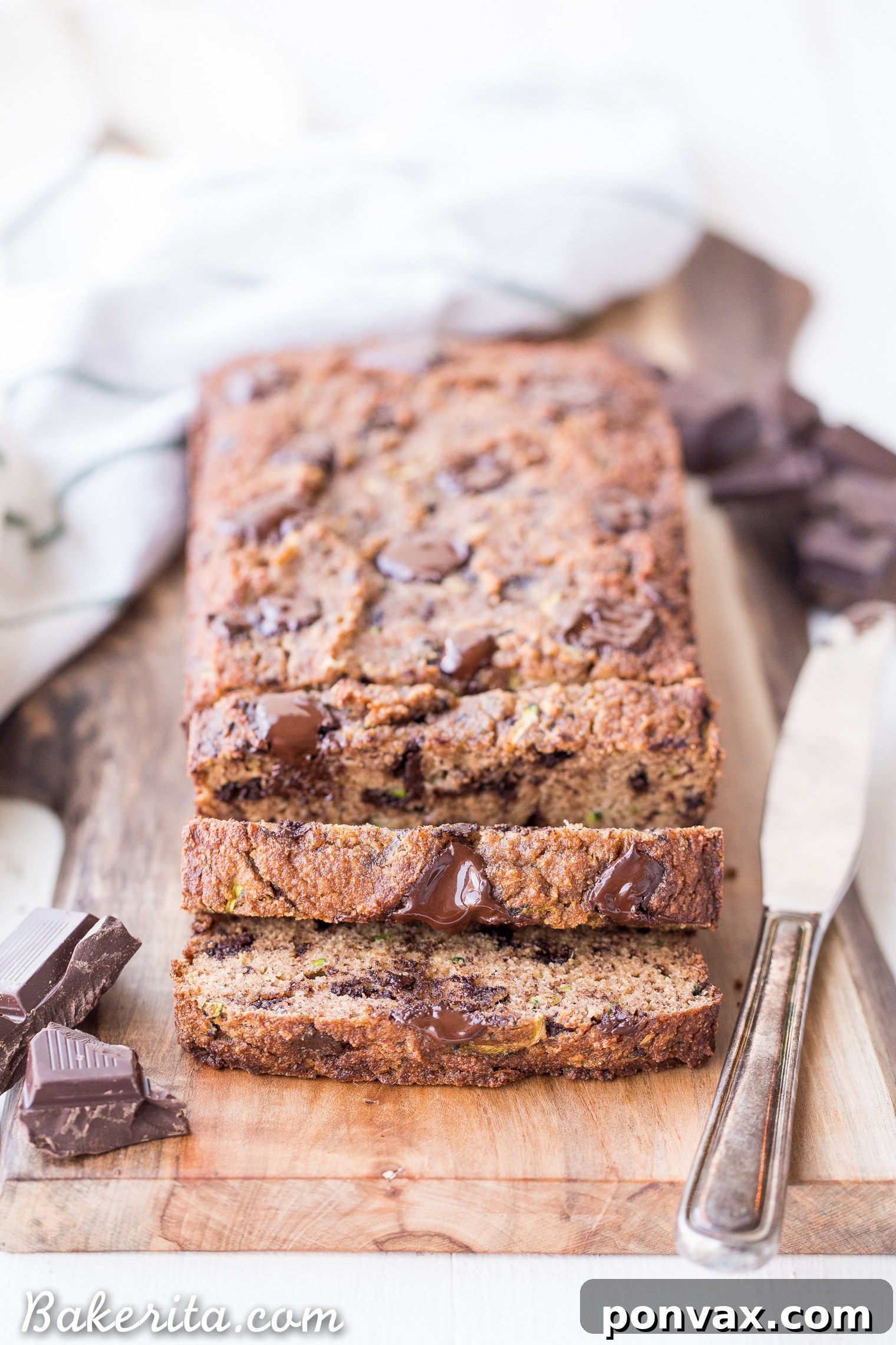 Paleo Zucchini Chocolate Chunk Delight 2 Moist Chocolate Chunk Zucchini Bread slices on a cooling rack