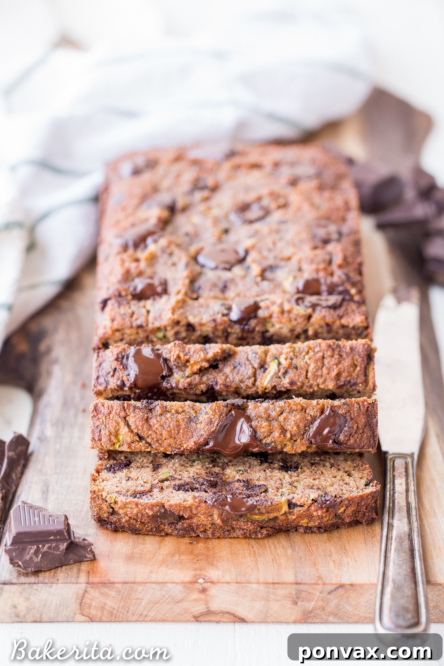 Paleo Zucchini Chocolate Chunk Delight 4 Sliced Chocolate Chunk Zucchini Bread with visible green streaks and melted chocolate