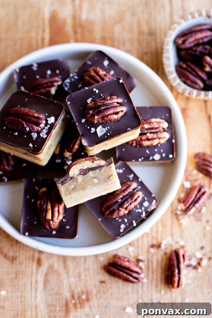 A hand holding a single No-Bake Vegan Turtle Bite, showing its layered structure.