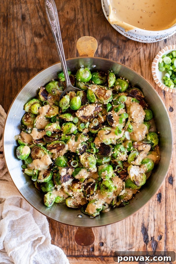 Glazed Miso Sesame Brussels Sprouts 2 Crispy Miso Sesame Brussels Sprouts, perfectly roasted and coated in a rich, savory tahini sauce, garnished with sesame seeds and green onions.