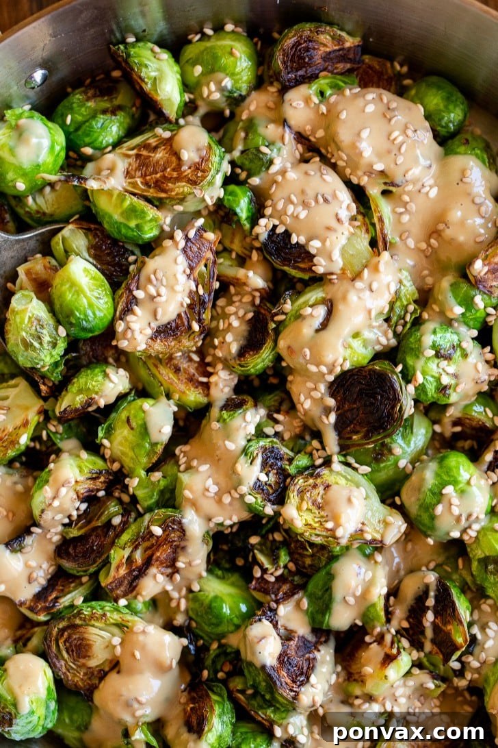 Glazed Miso Sesame Brussels Sprouts 3 Close-up of golden brown Miso Sesame Brussels Sprouts in a pan, glistening and ready to be sauced.