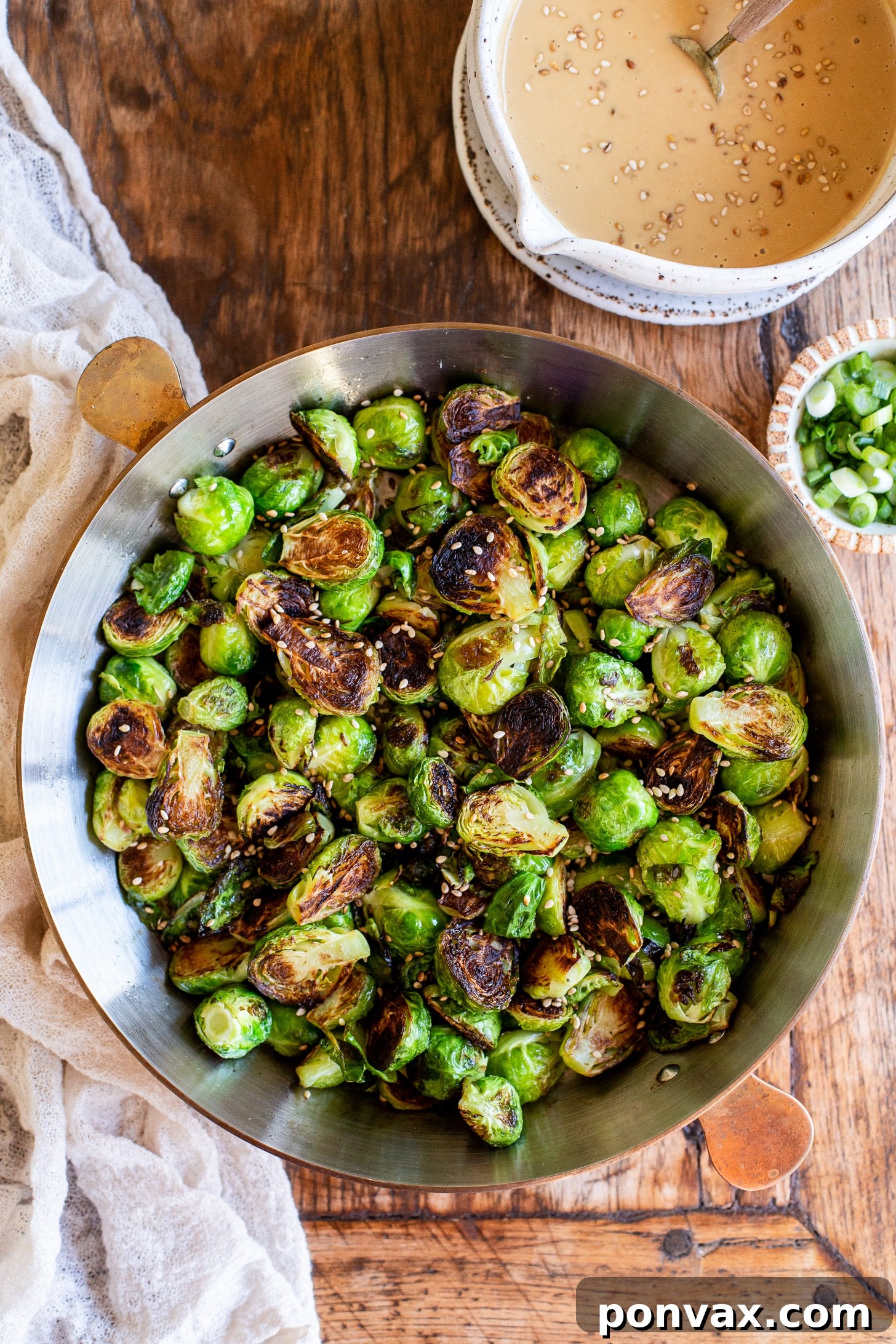 Glazed Miso Sesame Brussels Sprouts 4 Two halves of Miso Sesame Brussels Sprouts showing their crispy texture and vibrant green interior.