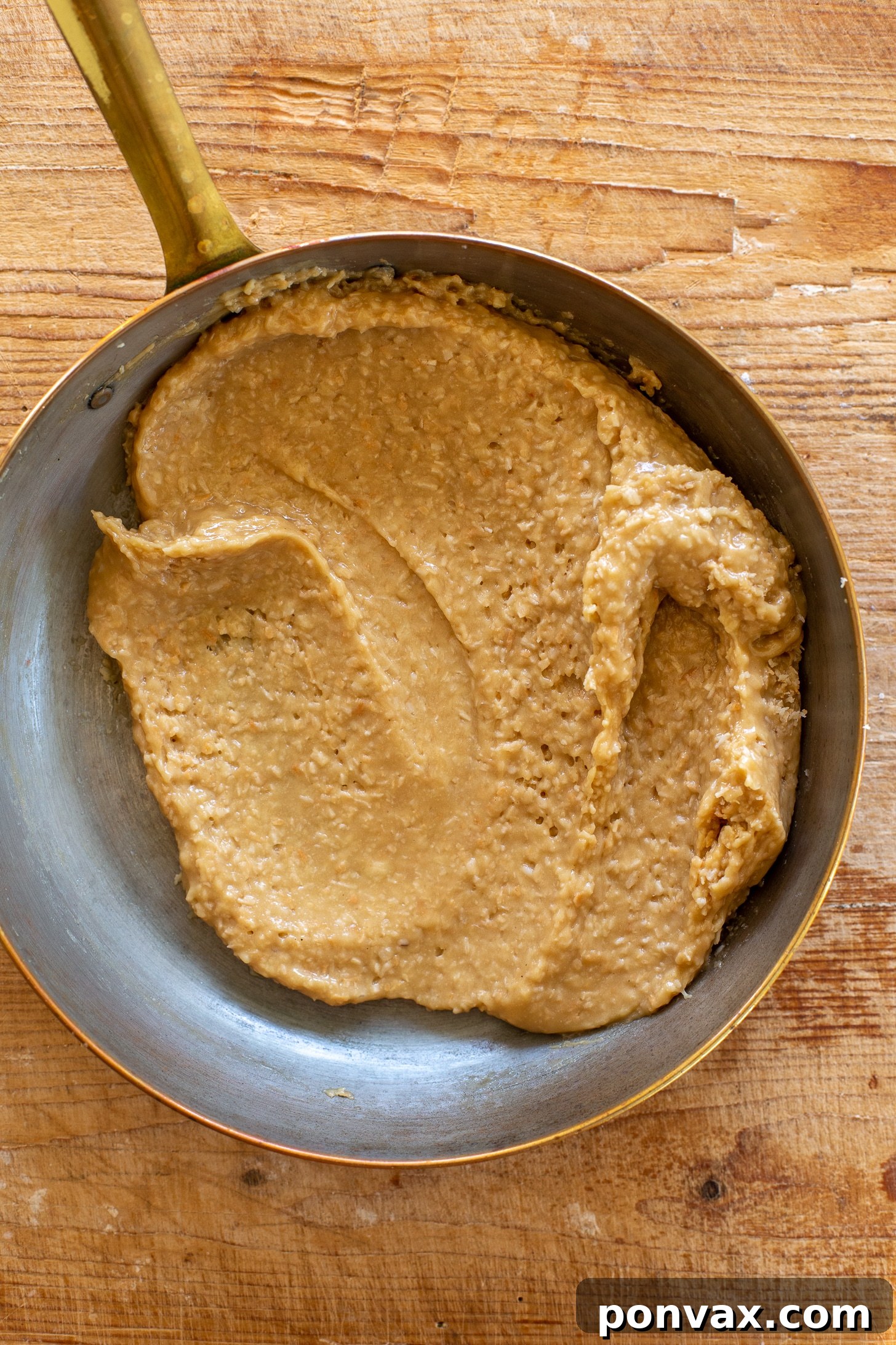Decadent Gluten-Free Coconut Caramel Brownies 6 Baked gluten-free vegan brownies cooling in a pan.