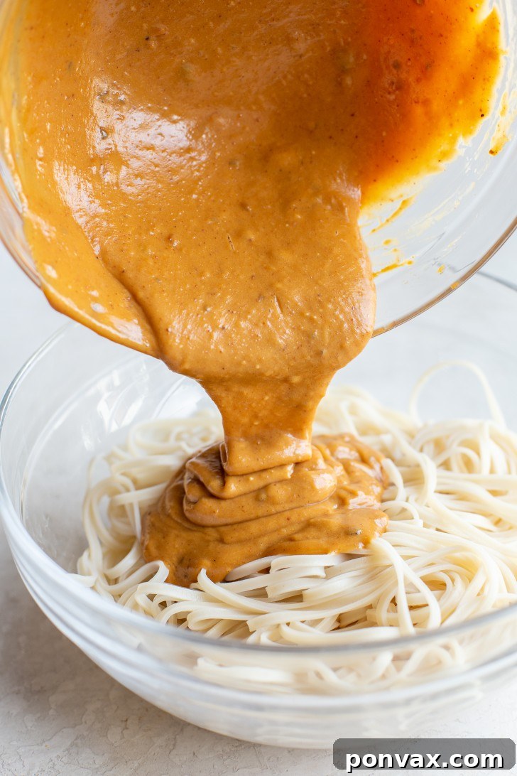Velvety Peanut Noodles in 5 Minutes 10 Drained noodles being added to the peanut sauce.