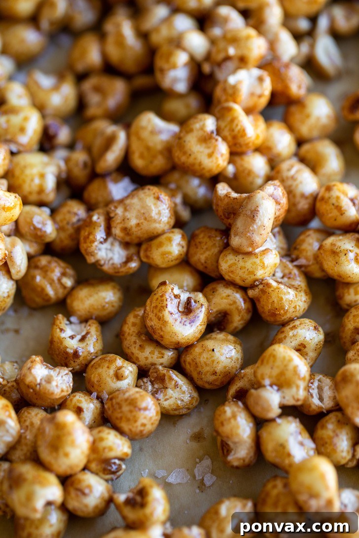 Maple Peanut Puffed Corn snack mix spread on a baking sheet