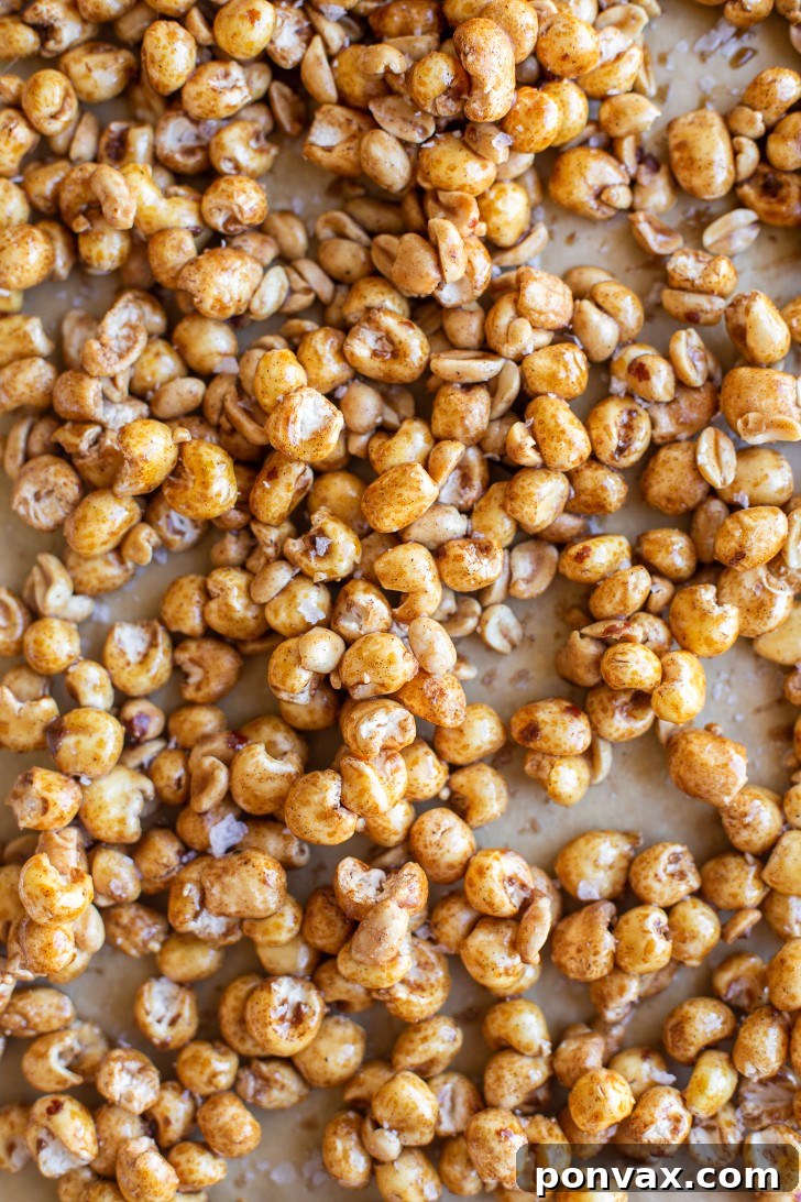 Maple Peanut Puffed Corn cooling on a baking sheet, ready to be broken apart