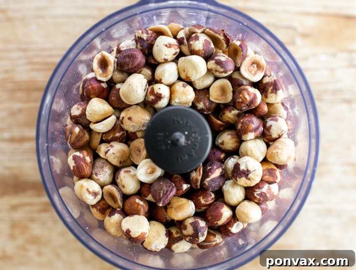 Hazelnuts transforming into butter in a food processor