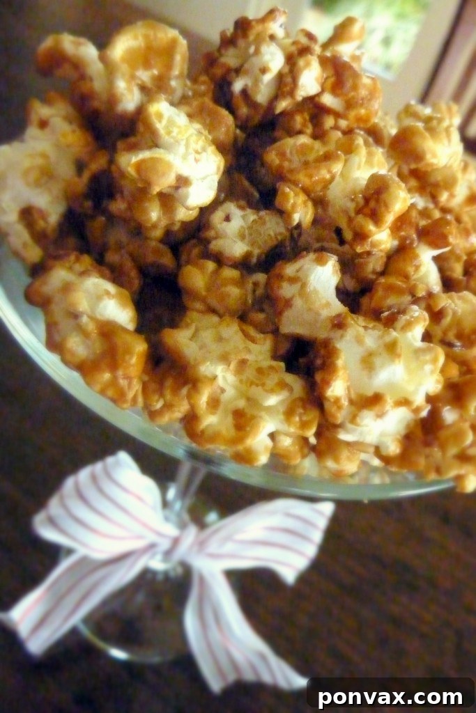A close-up of a generous pile of homemade gluten-free and vegan caramel corn, highlighting its glossy, golden coating.