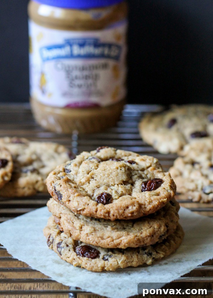These flavorful Cinnamon Raisin Peanut Butter Oatmeal Cookies use Cinnamon Raisin Peanut Butter for maximum flavor & the perfect soft and chewy texture! 