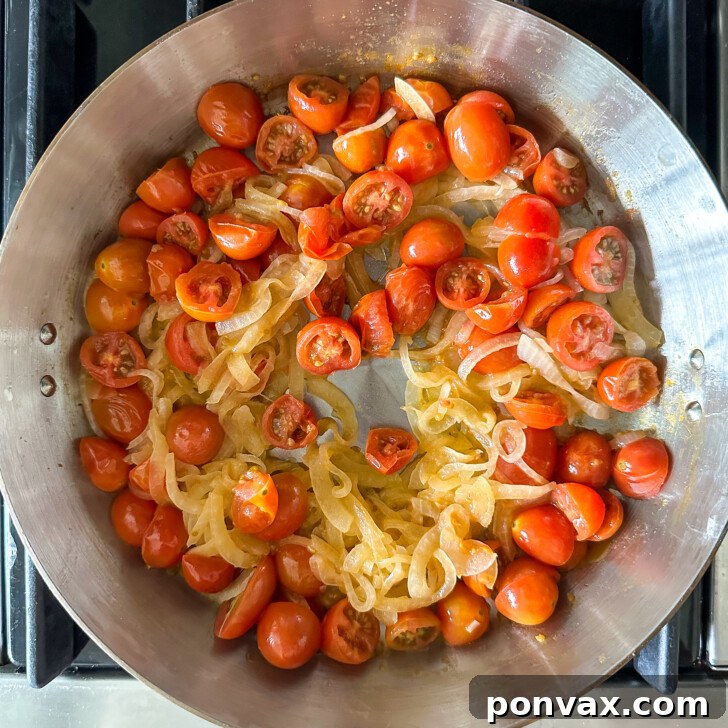 Velvety Tomato and Cannellini Stew 7 Cherry tomatoes added to the pan for the stew.