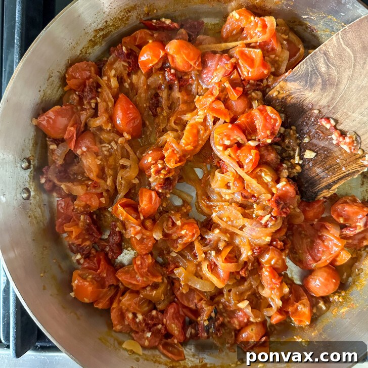 Velvety Tomato and Cannellini Stew 9 Tomato paste being stirred into the stew base.