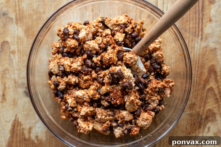 Tofu and black bean mixture coated in spices, ready for baking.