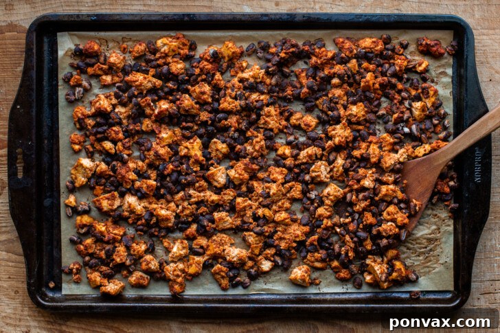 Crispy baked tofu and black bean chorizo filling on a baking sheet, fresh out of the oven.