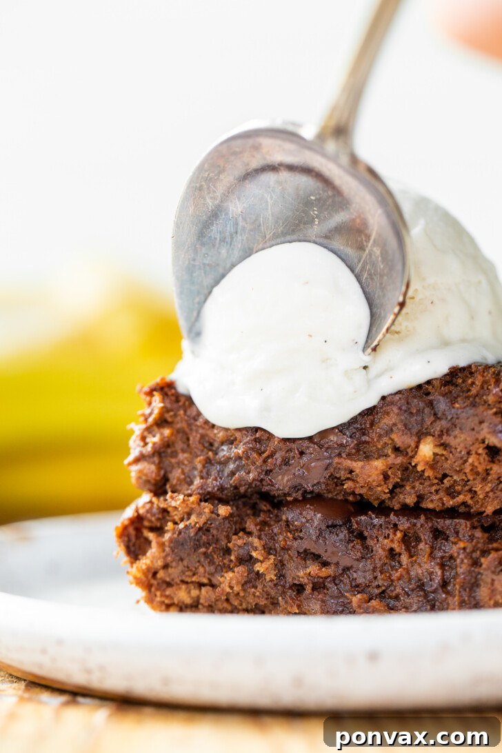 Three Vegan Flourless Banana Brownies stacked, showcasing their thickness.
