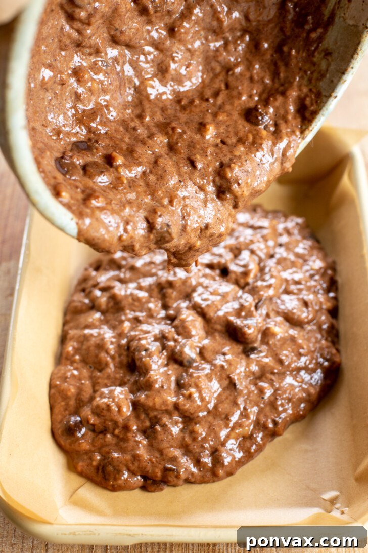 Folding chocolate chips into the brownie batter.