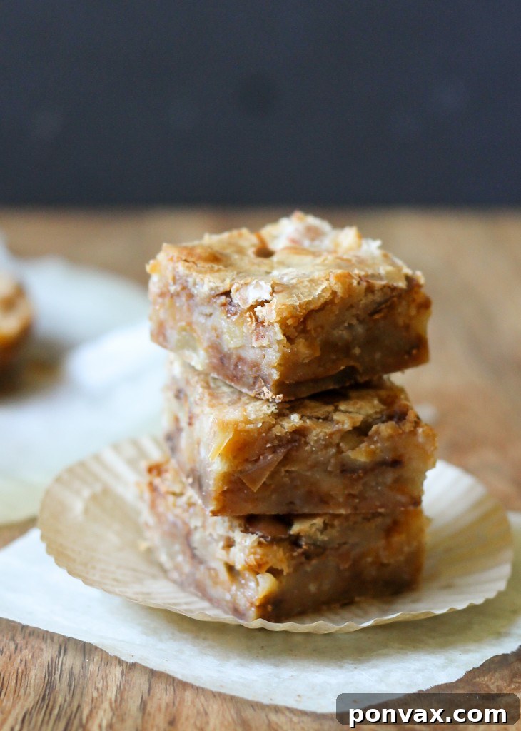 A close-up view of a baked pan of Apple Cinnamon Blondies, showing the perfectly even golden crust and delectable apple and cinnamon chip swirls.