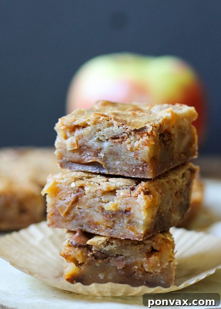 A large pan of freshly baked Apple Cinnamon Blondies, still warm from the oven, awaiting their cool-down period before being sliced into perfect squares.