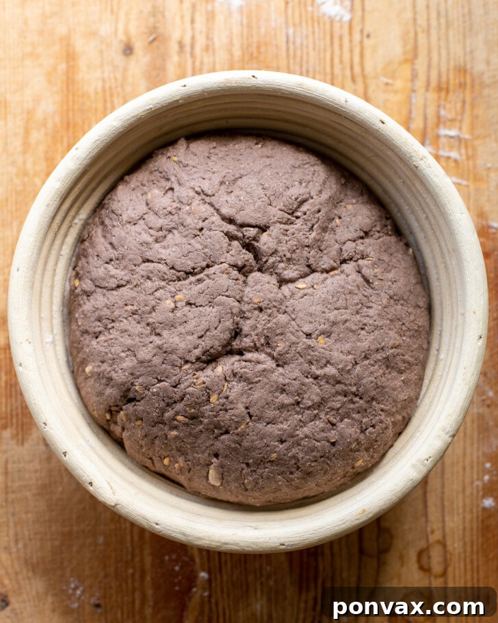 Step 7: Scoring the risen gluten-free rye bread dough with a sharp blade before baking.