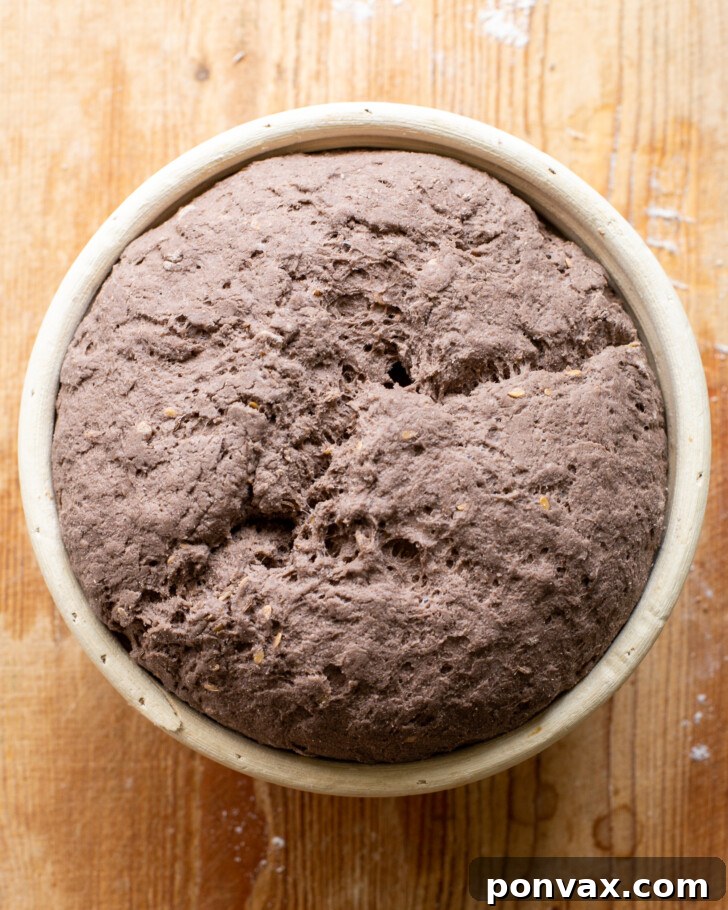 Step 8: A baked, golden-brown loaf of Gluten-Free Rye Bread, just out of the oven.