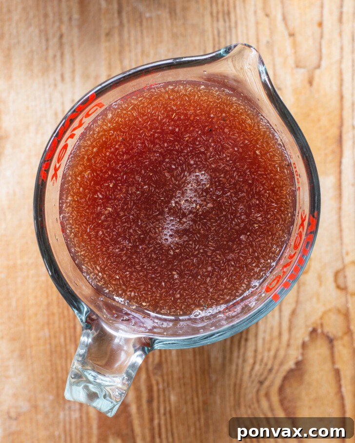 Step 2: Dry ingredients, including gluten-free flour, seeds, and cocoa powder, being mixed in a large bowl.