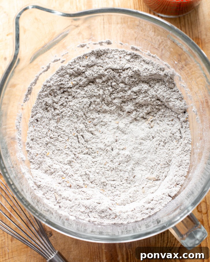 Step 3: The psyllium gel being added to the dry ingredients in a stand mixer.