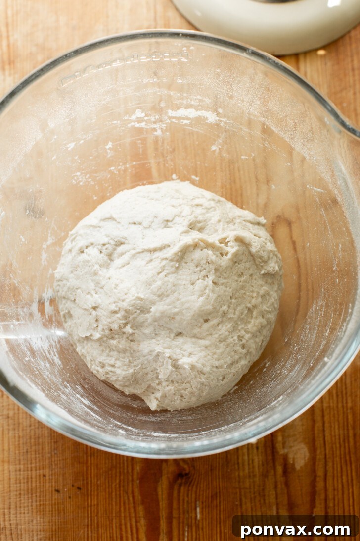 Shaped gluten-free bread dough placed in a banneton basket for rising.